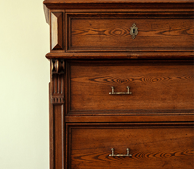A wooden antique chest of draws