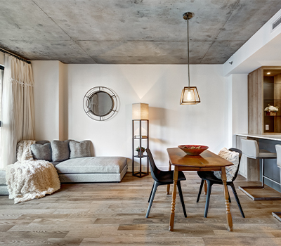 Contents in a home consisting of a sofa and a kitchen table with two chairs.