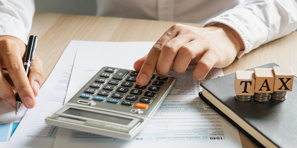 Person using calculator for tax