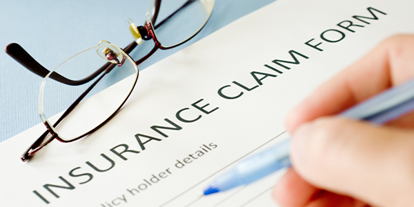 Someone filling in an insurance claim form