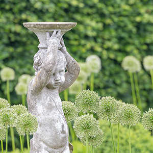 sculpture of a child in a garden